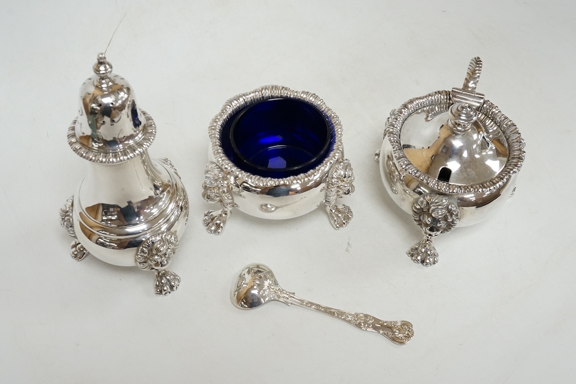 A George VI silver three piece condiment set by Mappin & Webb, London, 1937, with blue glass liners, one associated, pepper, 13.9cm, 26.5oz.